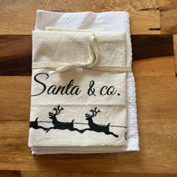 Set de repasador de algodon waffle y paño de liencillo estampado navideño trineos
